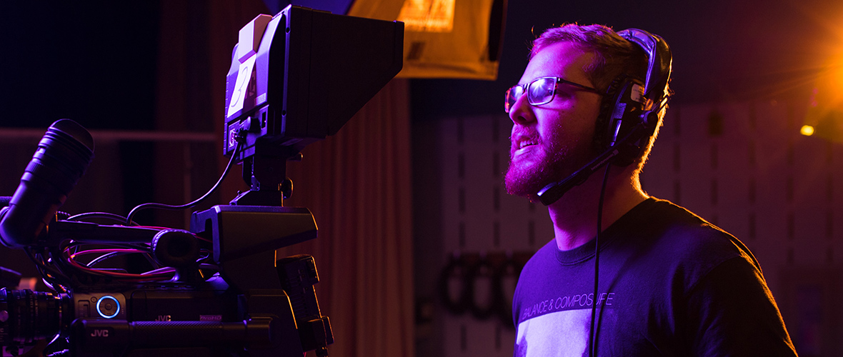 Communications student on camera assignment