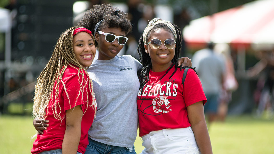 Students embrace during a homecoming tailgate party