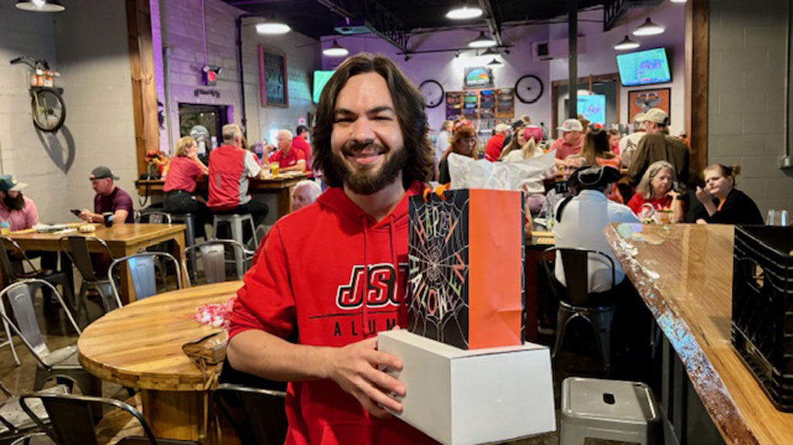 attendee and his prize, at watch party