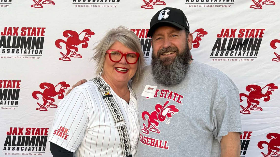 A proud alumni duo posing for a photo
