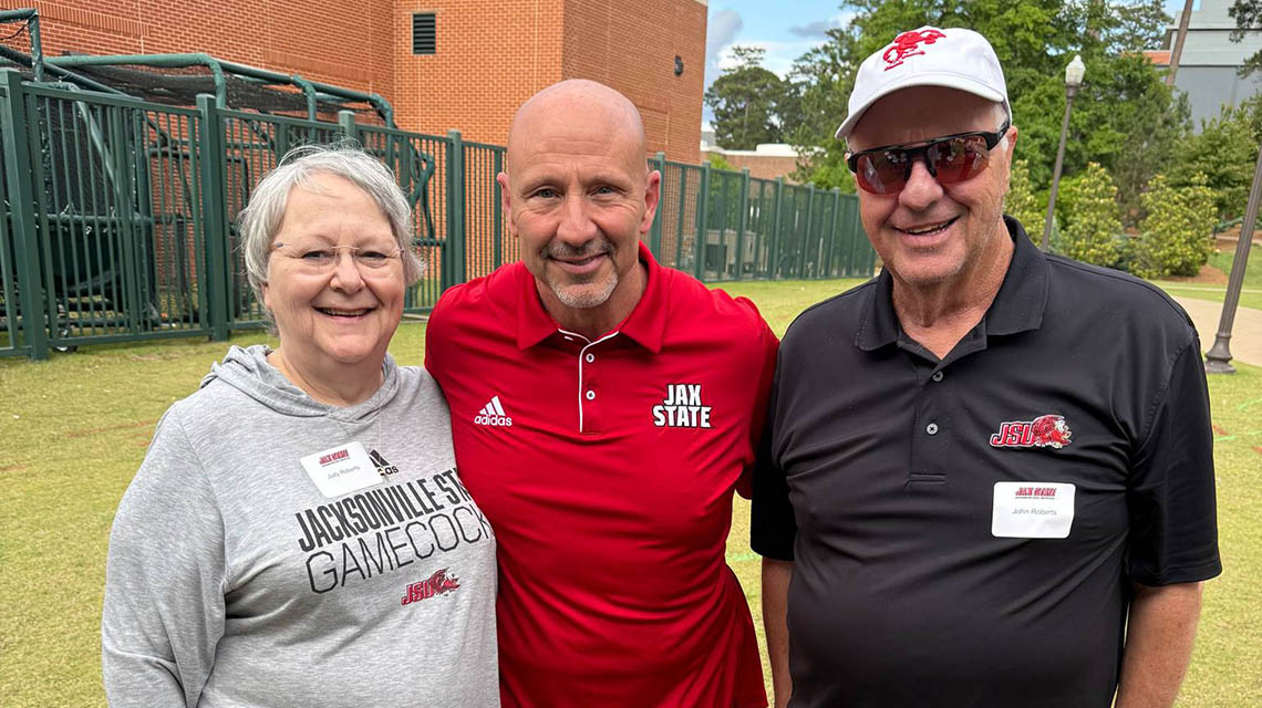 3 alumni pose for a photo