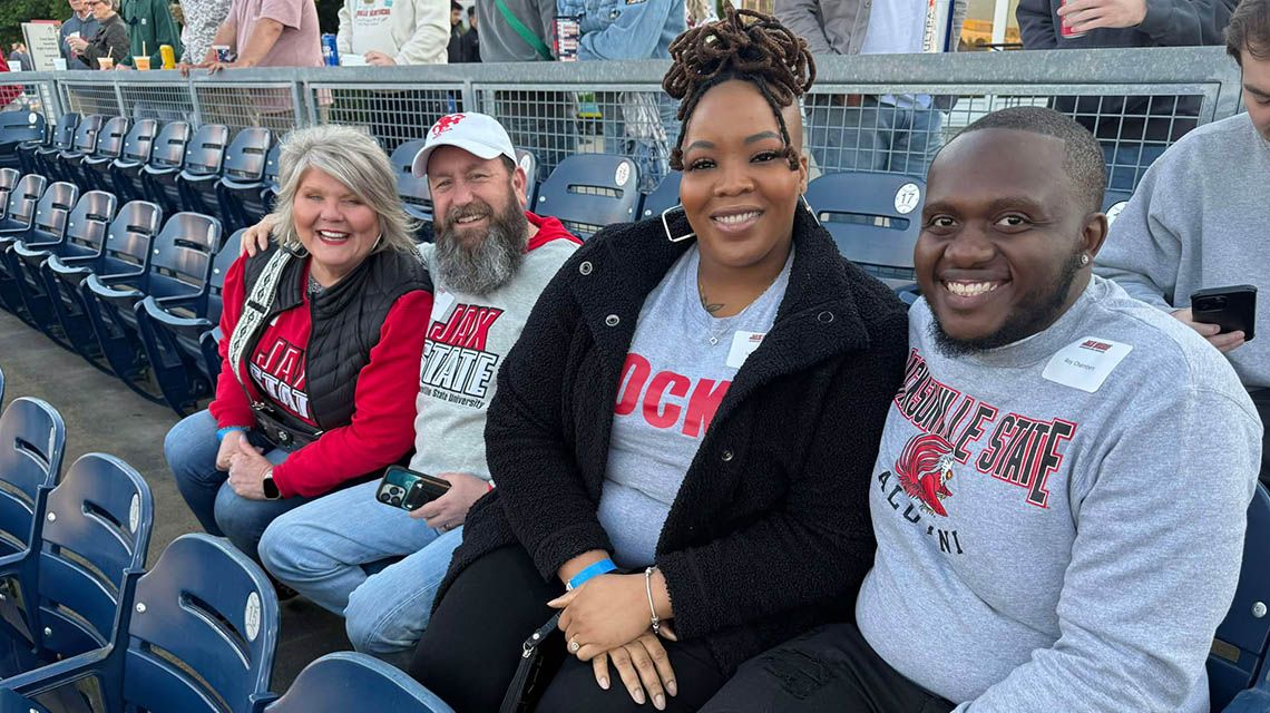 Alumni sit to watch the baseball game