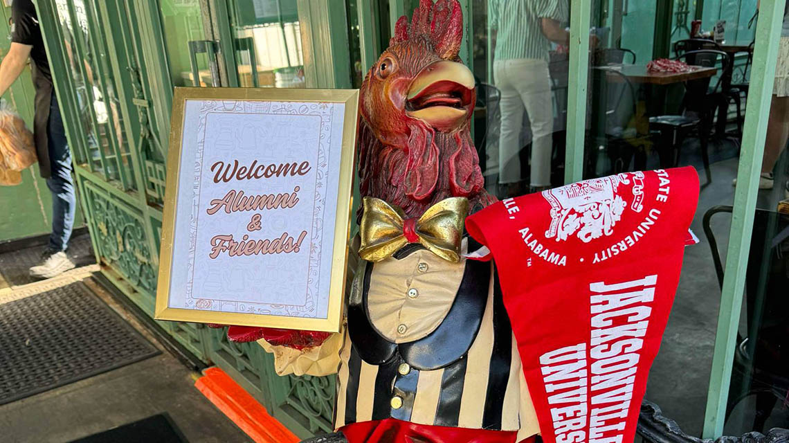 a rooster greeting alumni