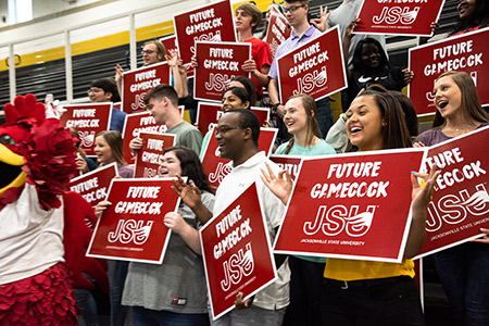 A group of students and Cocky, holding Future Gamecock signs