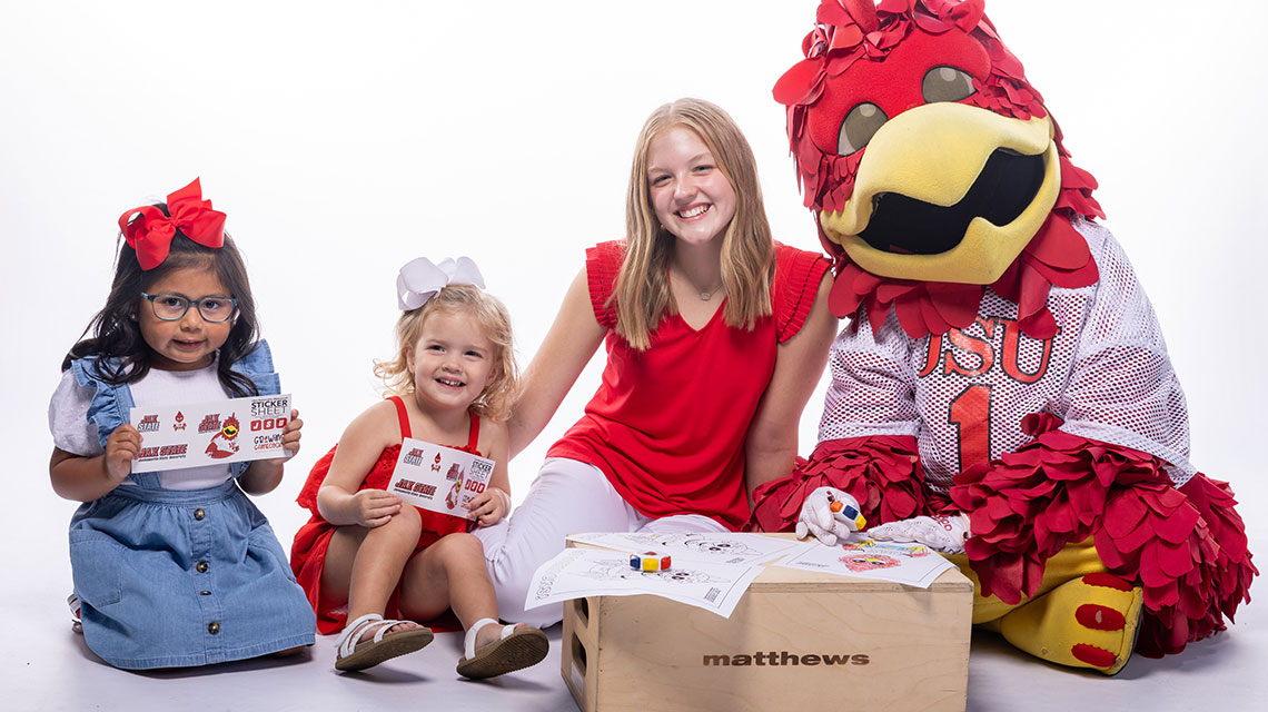 Children sit with Cocky as part of a promotion for Growing Gamecocks