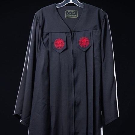 JSU's black graduation gown featuring the red university seal on each lapel