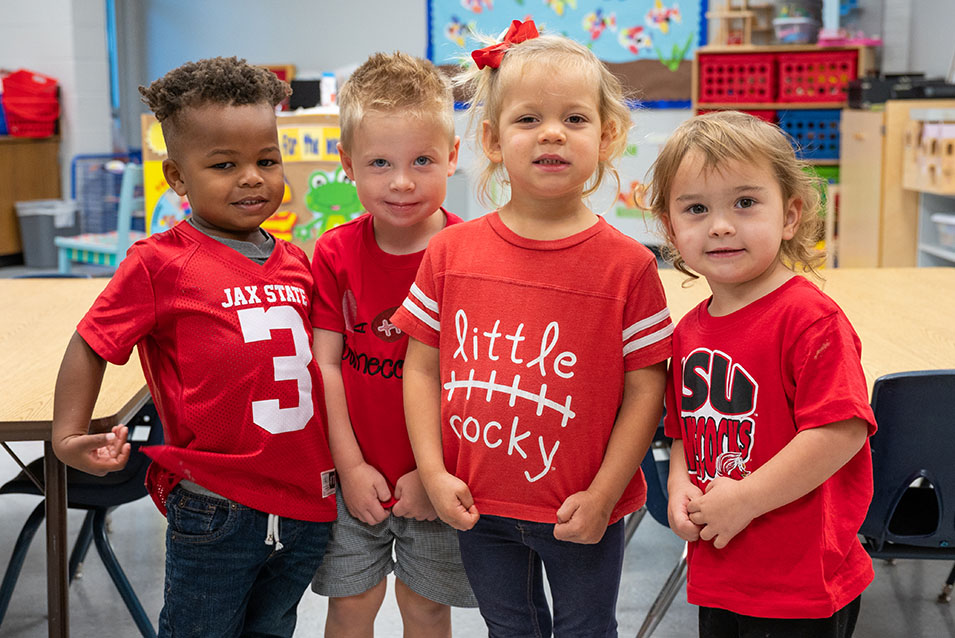 4 students at the cdc pose for a group photo with friends