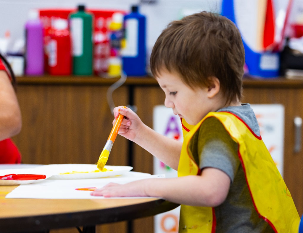 Student painting with brush