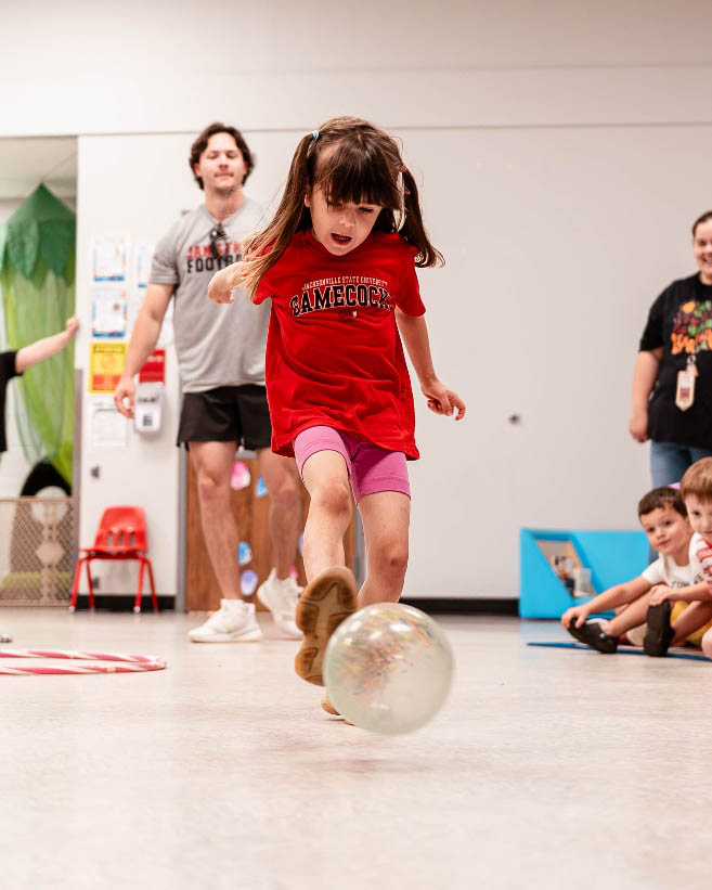 Young child kicking a ball