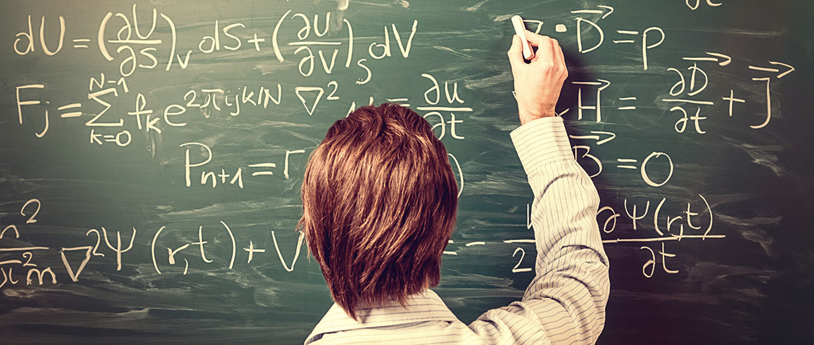 Mathematics teacher writing on chalkboard