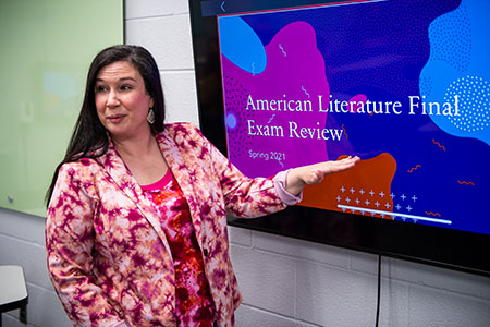 Dr. Andrea Porter points to screen while teaching