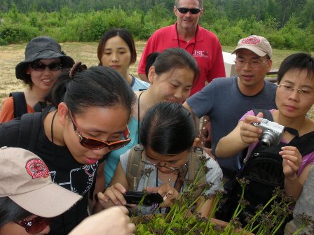 Chinese visitors looking at a Venus Fly Trap plant at the Canyon Center