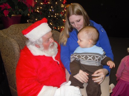 A baby sitting in Santa's lap at the Canyon Center
