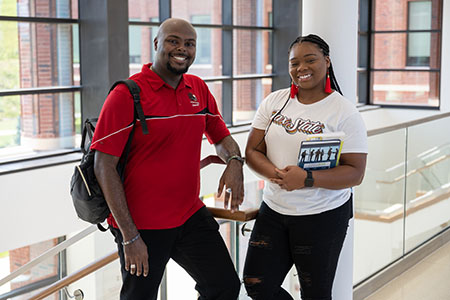 Two students showing JSU pride inside Merrill Hall