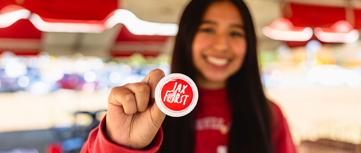 A proud JSU First-Gen student holds up her "I'm first" button