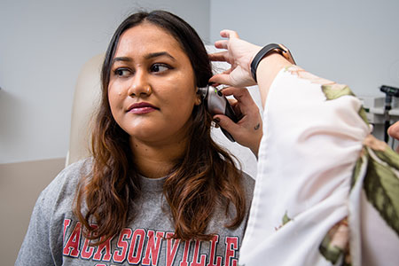 A student gets her ears checked at the Student Health Center