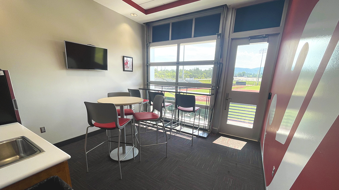 Each suite at Jim Case Stadium is equipped with a drink chiller and sink, cabinetry, a tv, high-top seating, and outdoor seats.
