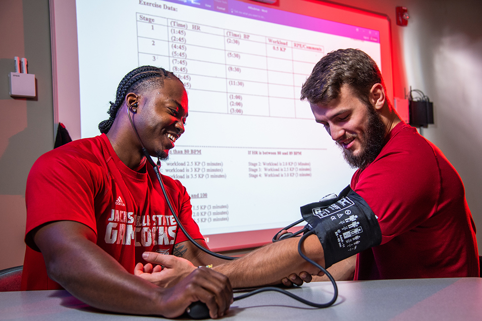 Student taking patient's blood pressure