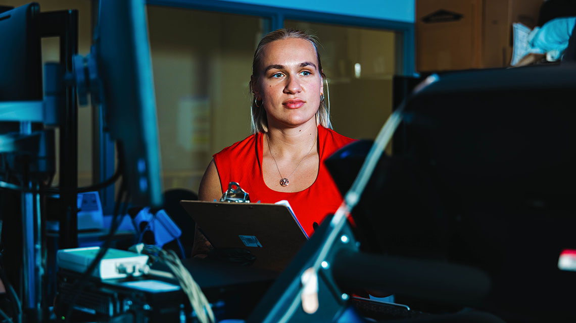 A female student examining a computer