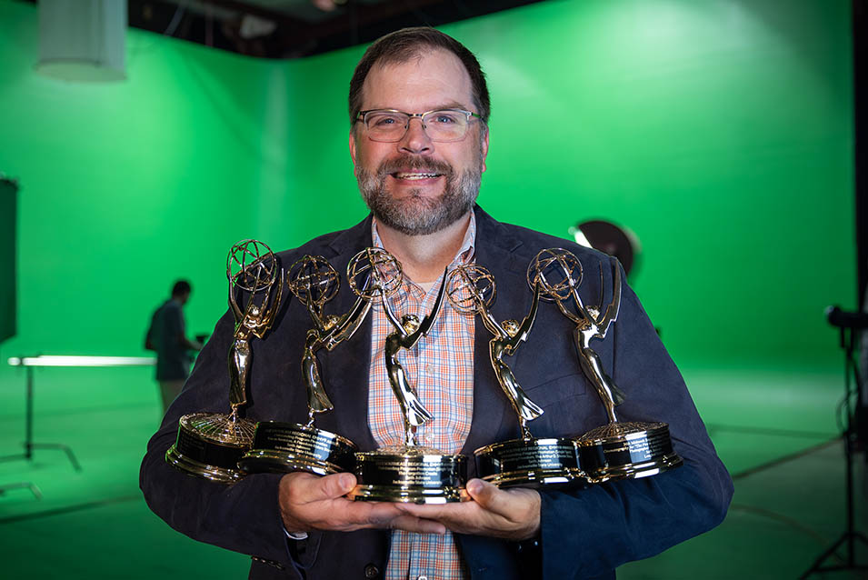 Seth Johnson holding Emmy Awards