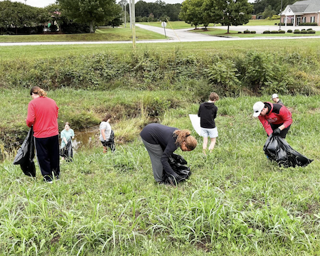 Students in the Jax State Honors Program pick up trash on the roadways.