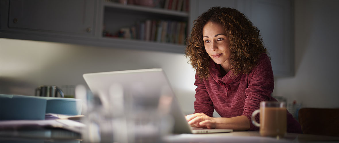 Adult female student looking at laptop