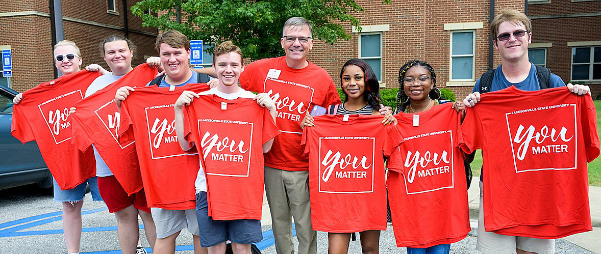 Dean of Students Terry Casey passes out t-shirts during the first week of classes, letting students know they matter. 