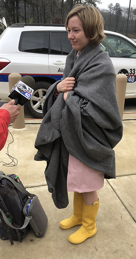 Madeline Miles, still in her rain galoshes and wrapped in a blanket, speaks with ABC 33-40s Stoney Sharp the morning after the tornado