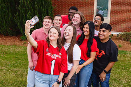 Students taking selfie outside recreation center