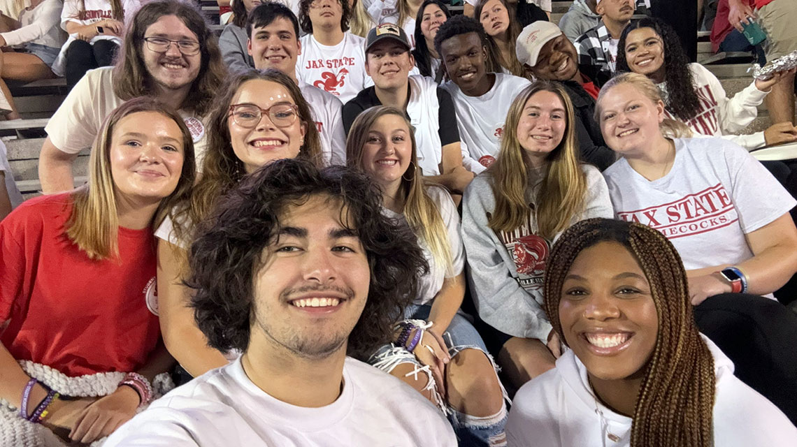 Freshman Forum Members wear their Jax State colors at a football game.