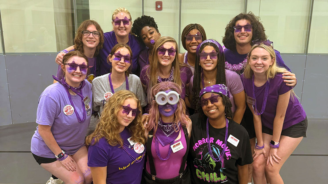 The purple group, dressed in purple and wearing silly purple accessories