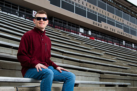 A visually impaired student at a football game