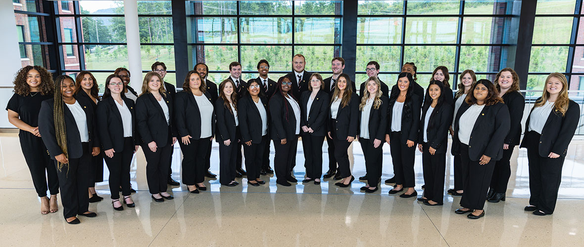 The 24-25 Ambassadors in the atrium of Merrill Hall